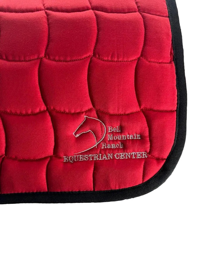 Contoured English Saddle Pad with Bell Mountain Logo. Red pad with silver stitching.