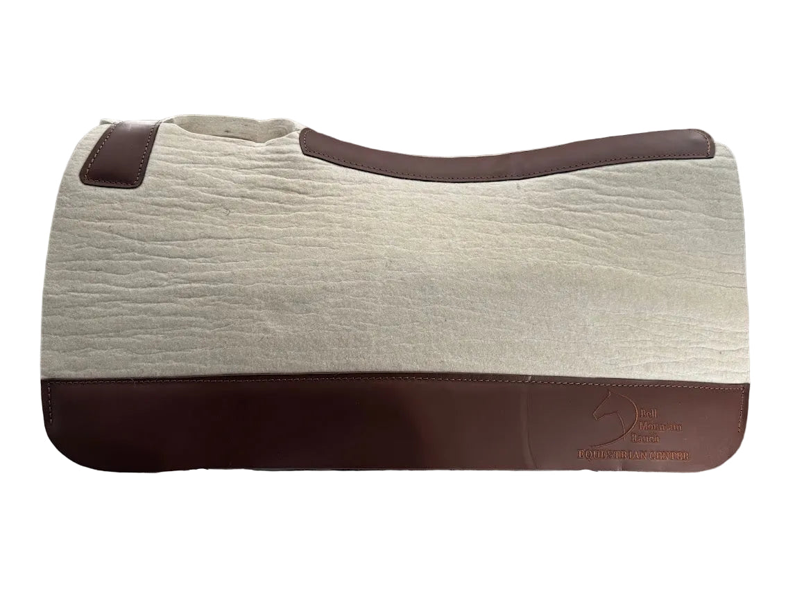 Natural Cream Color 100% Pressed Wool Saddle Pad with Brown Stitching and Leg Relief. Bell Mtn. Logo