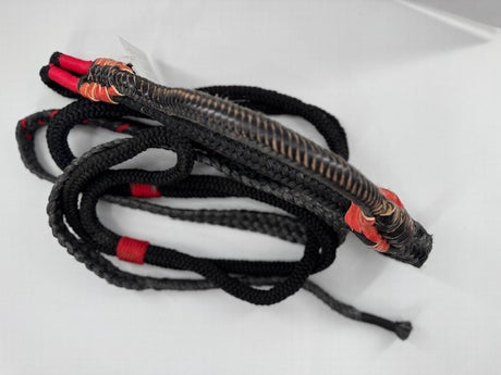 A traditional Brazilian bull riding rope designed for left-handed riders, featuring a tightly braided construction with a firm riser, secure handhold, and well-stitched block. The rope is primarily black with red accents.