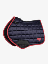 Navy blue quilted saddle pad with red border on a white background